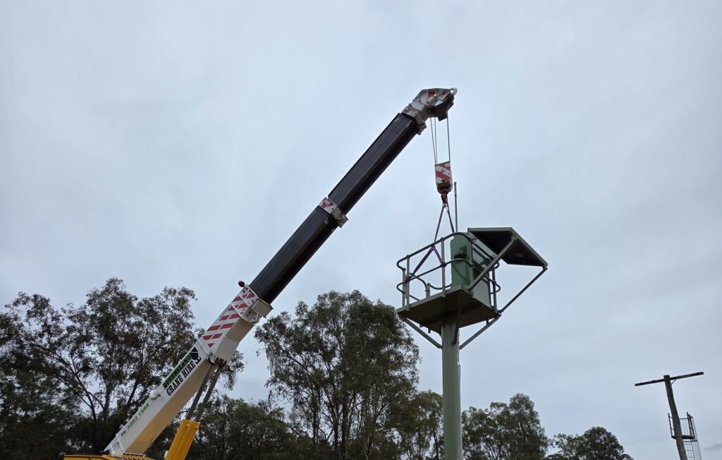 Flood warning station being installed by crane