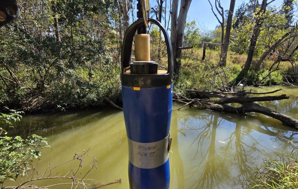 Water quality sonde being deployed in a creek