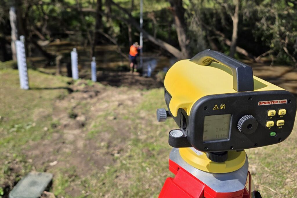 Laser level survey of new flood gauge boards